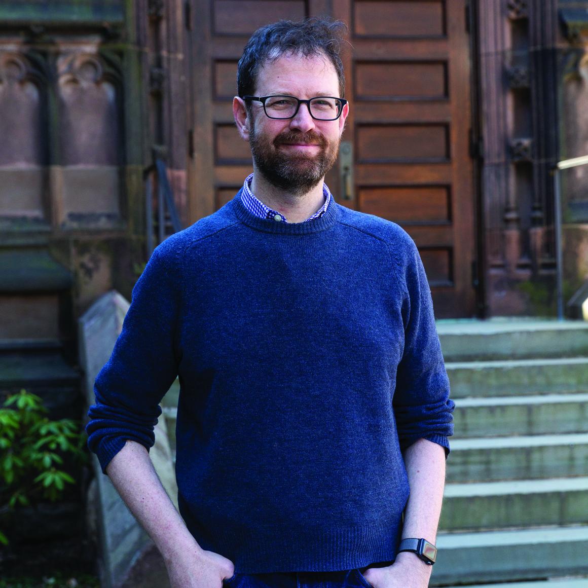 Professor Ken Norman portrait in front of building on campus